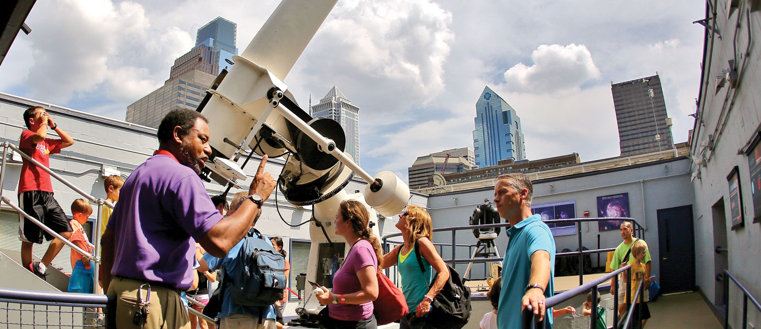 Crowds of Franklin Institute members gather on the roof in the Holt and Miller Observatory to do some Sun gazing.