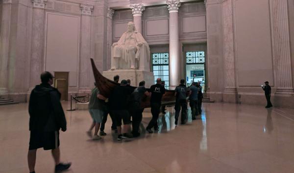 Men loading viking ship into the Franklin institute 