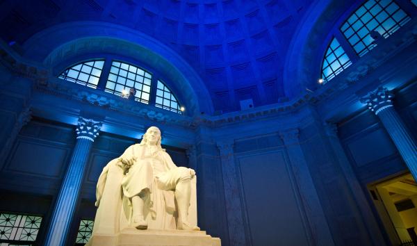 Benjamin Franklin Memorial statue with dramatic dark blue lighting