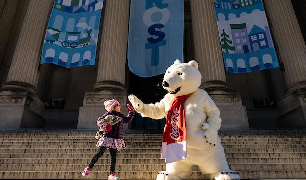 Child and Coca-Cola Polar Bear on front steps