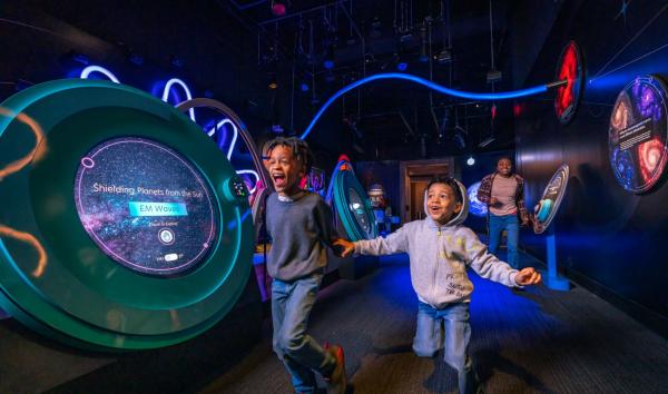 Boys running through exhibit space