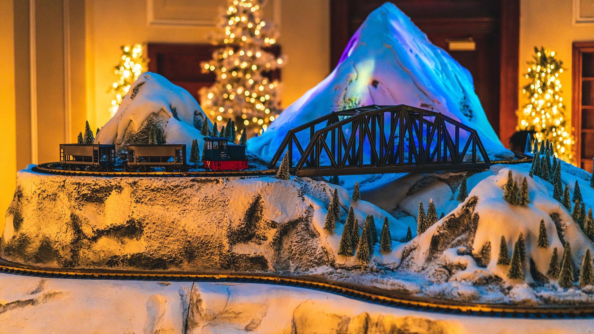 A model train navigates a wintry mountain scene at Franklin Frost.