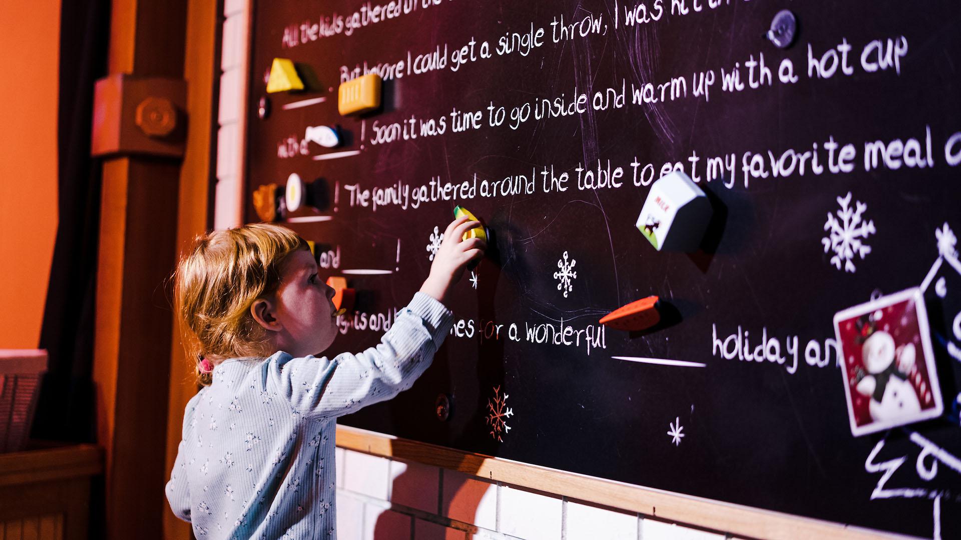 A young visitor works on their "perfect holiday card" at Franklin Frost.