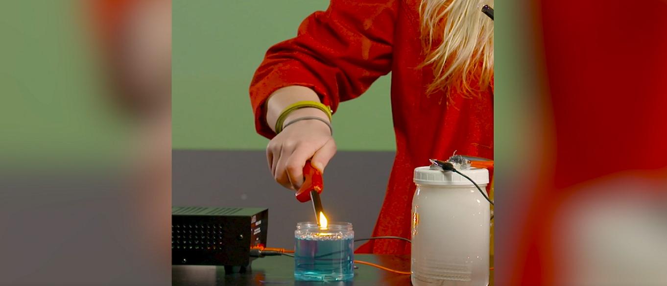 Science interpreter demonstrating electrolysis