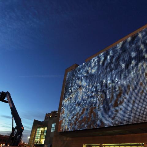 The façade of the newly installed Shimmer Wall just after sunset.