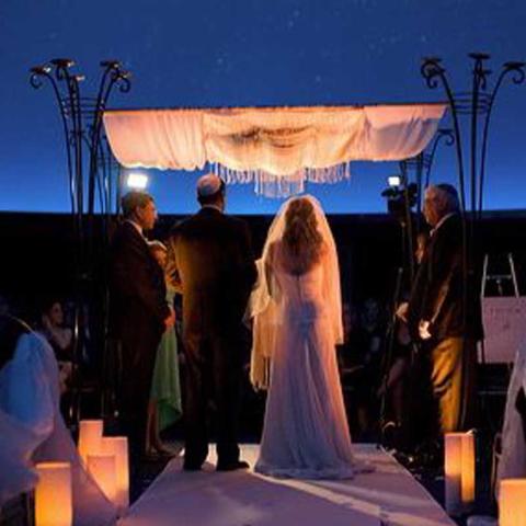 A wedding ceremony being held in Fels Planetarium at The Franklin Institute.
