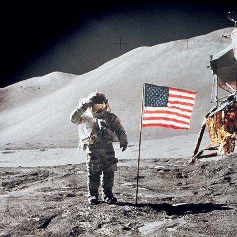Astronaut David Scott gives salute beside U.S. flag during EVA