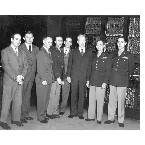 ENIAC engineers and army officials standing in front of the ENIAC.