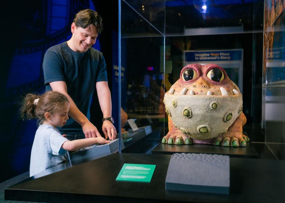 Man and child with Gronckle | Universal Theme Parks: The Exhibition | The Franklin Institute