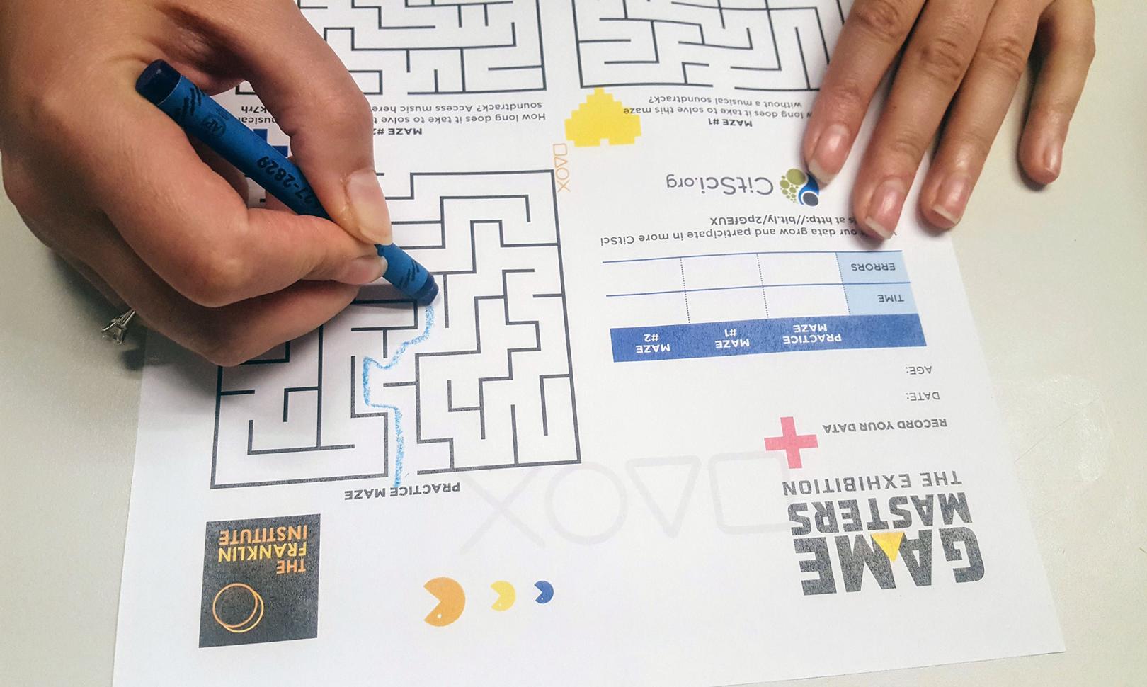 hands completing a maze puzzle
